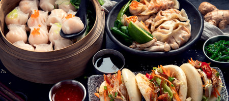 Chinese dumplings, soy sauce, dim sum on a dark background. Traditional Asian food concept. Top viewの写真素材