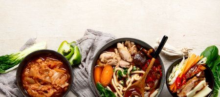 Korean traditional food. Bibimbap, traditional Korean dish, rice, vegetables, Kimchi on a white background. Top view. Panorama with copy space.の写真素材