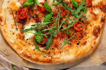 Hot homemade pizza Margherita on a light background Cheese in a pizza crust. Tasty vegetable pizza. Top view.の写真素材
