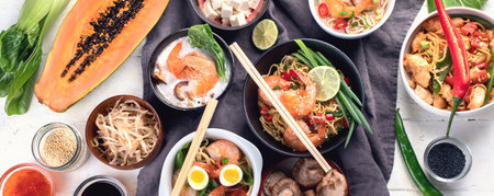 Traditional Asian cuisine on a gray background. Thai dishes concept. Top view. Panorama.の写真素材