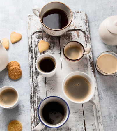Various cups of coffee on a gray background. Coffee time concept. Top view.の写真素材