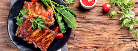 Barbecue spare ribs with sauce and herbs on a rustic wooden background. Top view. Panorama.の写真素材