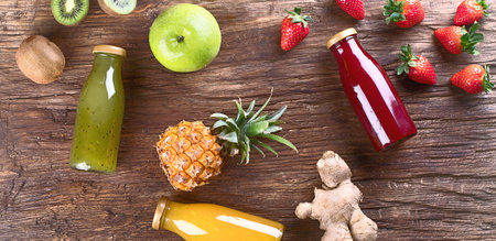 Juice and smoothie with fruits on a wooden background. Top view. Healthy diet and detox concept.の写真素材