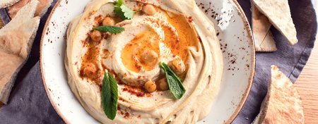 Healthy Hummus and pita bread on a wooden background. Middle eastern food. Top view. Panorama.の写真素材