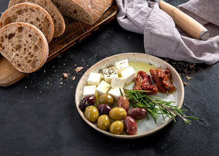 Olives, olive oil and ciabatta bread on dark background. Top view.の写真素材