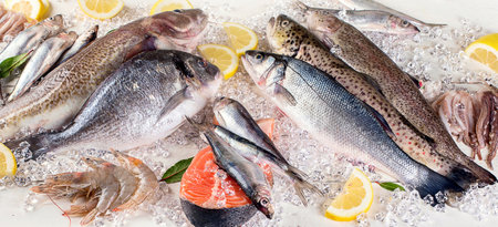 Fresh fish and seafood on a white wooden background. Healthy eating. Top view.の写真素材