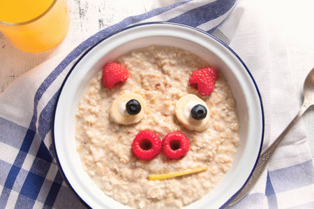 Cute pig face shaped oatmeal for kids breakfast. Top view.の写真素材