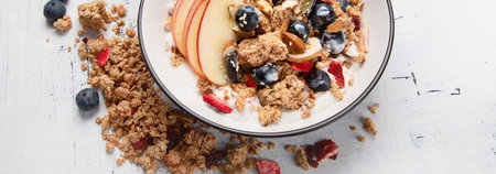 Bowl of granola with yogurt and fresh fruits for healthy breakfast. Top view. Panorama.の写真素材