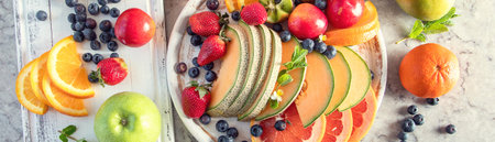 Fresh Mixed Fruit plate. Healthy food concept. Top view. Panorama.の写真素材