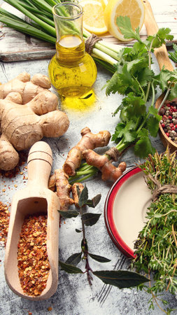 Assorted herbs and spices on a gray background. Healthy cooking concept. Top view.の写真素材