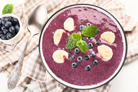 Smoothie bowl with fresh blueberries for healthy breakfast on a white background. Top view.の写真素材