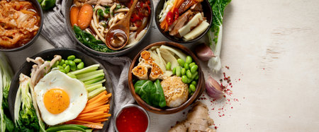 Korean traditional food. Bibimbap, traditional Korean dish, rice, vegetables, Kimchi on a white background. Top view. Panorama with copy space.の写真素材