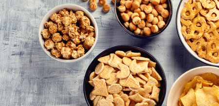 Mix of crackers and popcorn on a gray background. Top view. Panorama with copy space.の写真素材