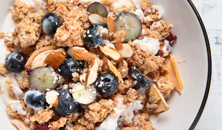 Bowl of granola with yogurt and fresh fruits for healthy breakfast. Top view. Panorama.の写真素材