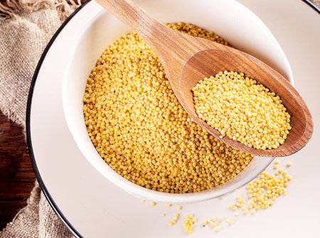 Organic millet seeds on a wooden background. Top view.の写真素材