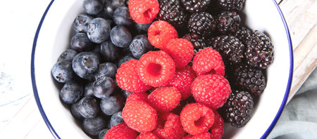 Different fresh berries in a bowl. Antioxidant food concept. Top view. Panorama.の写真素材