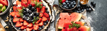Homemade Strawberry and Blueberry tart with watermelon and jam for dessert on a gray background. Top view. Panorama with copy space.の写真素材