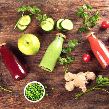 Fresh organic fruits, vegetable smoothies and juices on a wooden background. Detox diet. Top viewの写真素材