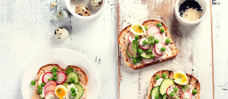 Healthy spring toasts on a gray background Healthy breakfast concept. Top view. Panorama.の写真素材