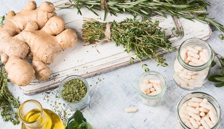 Healing herbs, essential oils and homeopathic pills. Homeopathy and Alternative Medicine. Top view.の写真素材