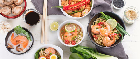 Traditional Asian cuisine on a white background. Thai dishes concept. Top view. Panorama.の写真素材