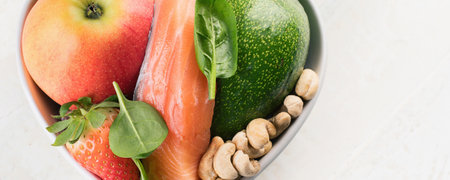Foods for healthy Heart salmon, apple, avocado, nuts. Healthy food concept. Top view. Panorama.の写真素材