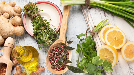 Assorted herbs and spices on a gray background. Healthy cooking concept. Top view.の写真素材