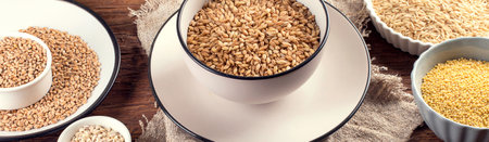 Ancient grains, seeds, beans on a wooden background. Top view. Panorama.の写真素材