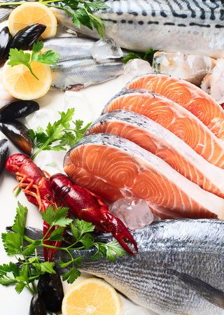 Fresh fish and seafood with lemon and herbs. Healthy eating concept. Top viewの写真素材