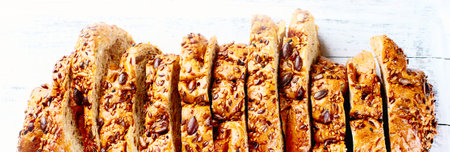Fresh wholegrain bread on rustic wooden table. Top view, panorama, bannerの写真素材