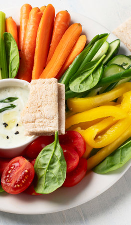 Healthy snacks. Fresh vegetables with sauce on a white background. Top view.の写真素材
