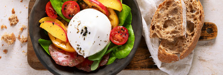 Salad with burrata cheese, lettuce and tomatoes. Healthy eating diet with fiber, vitamins and antioxidants, panorama, bannerの写真素材