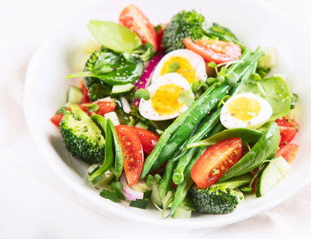 Vegetables salad with eggs, green beans, broccoli and tomatoes. Diet menu. Healthy eating. Selective focusの写真素材