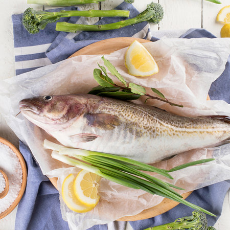Raw code fish before cooking with lemon, salt and herbs. Top view.の写真素材