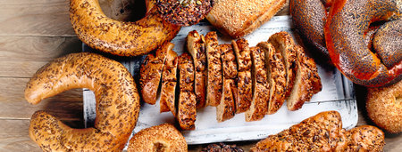 Fresh wholegrain mixed bread on rustic wooden table. Top view, panorama, bannerの写真素材