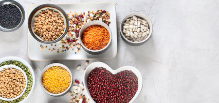 Assortment of colorful legumes. Healthy eating concept. Vegan proteins. Top view with copy space,...