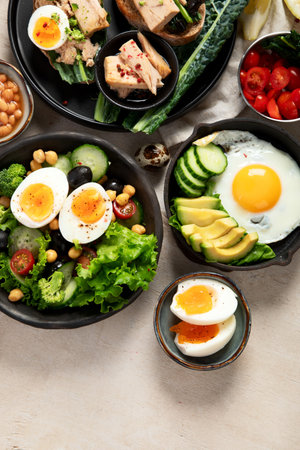Set with various dishes with fried, boiled and scrambled eggs on white background. Top view. Copy space.の写真素材