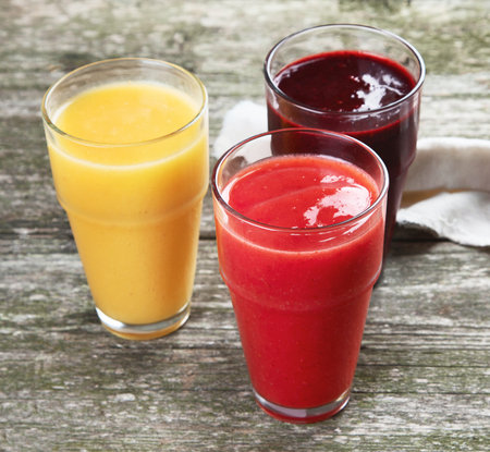 Different types of smoothies on wooden background. Healthy clean and detox dietの写真素材