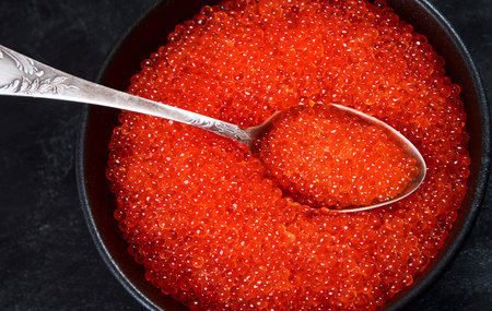 Salmon roe. Red caviar on black background. Top viewの写真素材