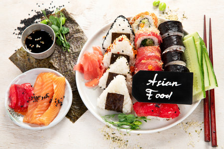 Assorted sushi nigiri and maki set. A variety of Japanese sushi with tuna, crab, salmon on a light background. Top view.の写真素材