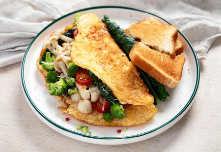 Omelette stuffed with mushrooms, tomatoes and cheese on white background. Top view.の写真素材
