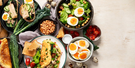 Set with various dishes with fried, boiled and scrambled eggs on white background. Top view. Copy space.の写真素材