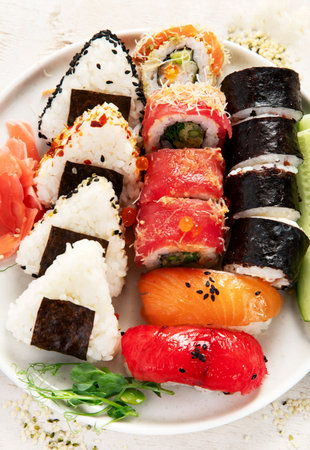 Assorted sushi nigiri and maki set. A variety of Japanese sushi with tuna, crab, salmon on a light background. Top view.の写真素材
