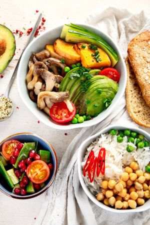 Healthy vegetarian and vegan salad and Buddha Bowls with vitamins, antioxidants, protein on light background. Top view.の写真素材