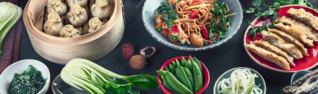 Assorted Chinese food on dark background. Asian food concept. Top view. Panorama, bannerの写真素材