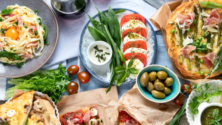 Italian cuisine on rustic wooden table. Different types of pizza, pasta, snacks and capreze. Healthy...
