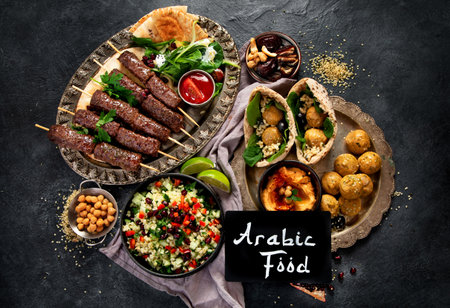 Middle Eastern or Arabic cuisine with a variety of dishes on a dark background. Top view..の写真素材