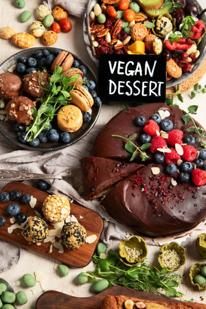 Various vegan desserts - chocolate cake, banana cake, nuts and sweets on a light background. Top view.の写真素材