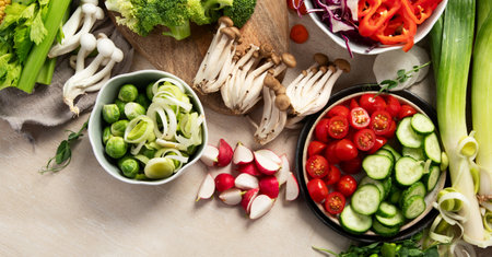 Fresh chopped vegetables on a plate and in bowls. Vegetarian, vegan food on a light background. Top view. Copy space.の写真素材