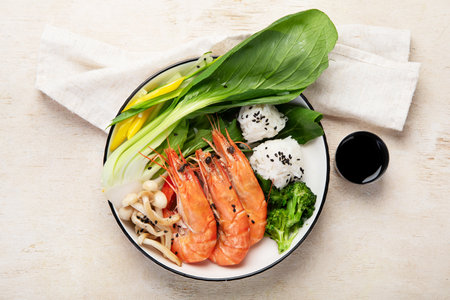 Shrimps with rice and vegetables on a light background. Thai dish. Asian Food. Top view.の写真素材
